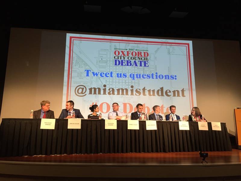 * candidates for City Council sit on stage